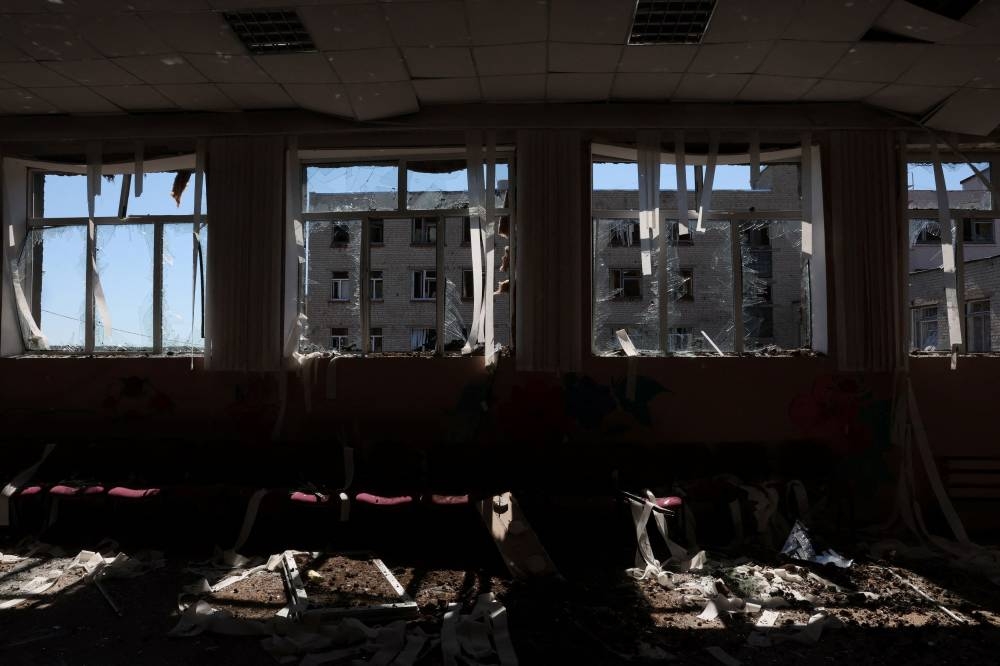 Debris lies on the floor of an auditorium in a school that was hit in its yard by overnight shelling as Russia’s attack on Ukraine continues in Kharkiv, Ukraine June 27, 2022. ― Reuters pic