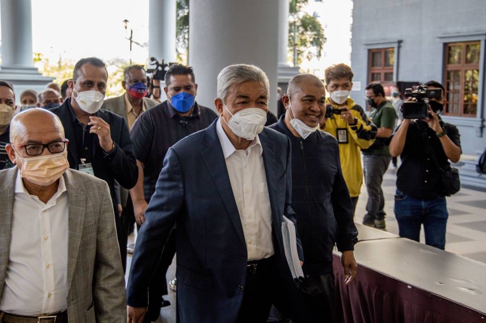 Datuk Seri Zahid Hamidi (centre) arrives at the Kuala Lumpur Court Complex on June 27, 2022. — Picture by Firdaus Latif