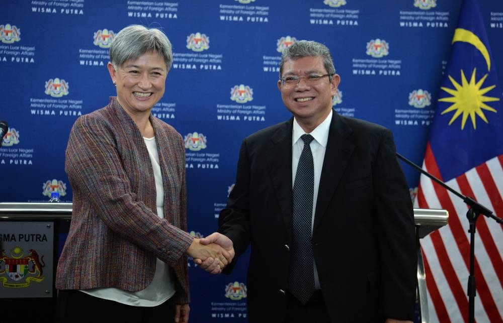 Foreign Minister Datuk Seri Saifuddin Abdullah shakes hands with Australian Foreign Minister Senator Penny Wong after holding a press conference at Wisma Putra, June 28, 2022. — Bernama pic 