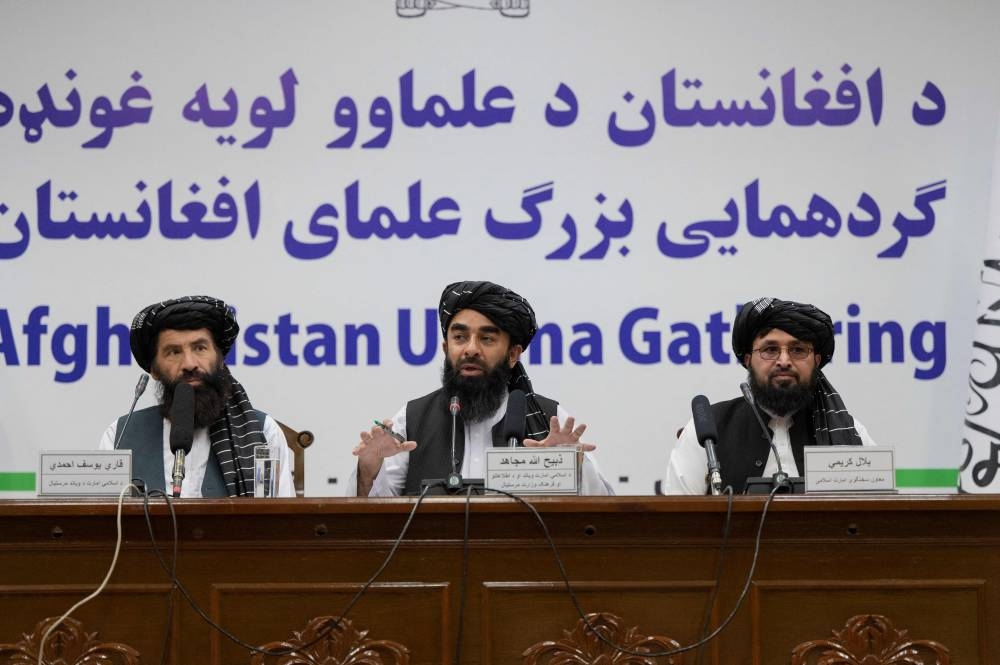 Taliban spokesman Zabihullah Mujahid (centre) speaks during a press conference in Kabul on June 30, 2022. ― AFP pic