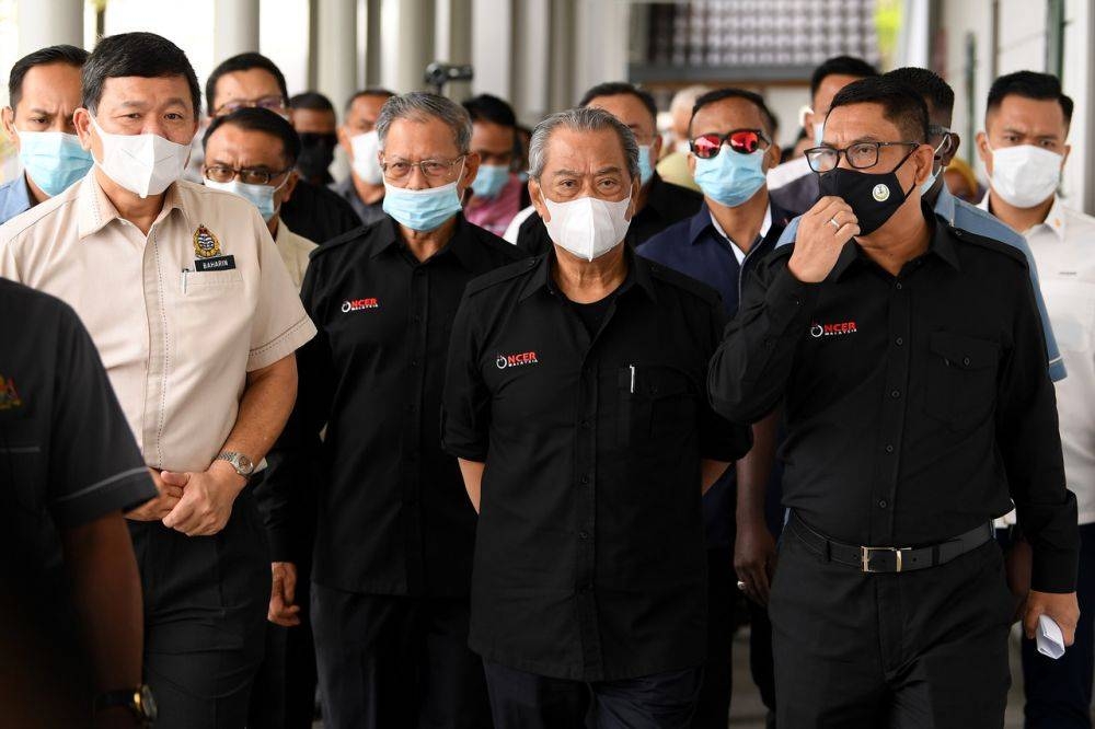 Tan Sri Muhyiddin Yassin (centre) is pictured with Datuk Seri Ahmad Faizal Azumu during a visit to the Pangkor Jetty September 15, 2020. — Bernama pic