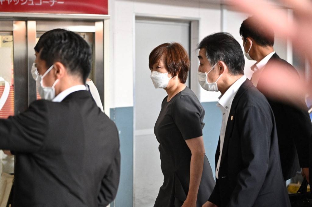 Akie Abe (centre), wife of former Japanese prime minster Shinzo Abe, arrives by train in Nara before heading to the Nara Medical University Hospital in Kashihara, Nara Prefecture, where her husband was transferred after being shot during an election campaign in Nara on July 8, 2022. — AFP pic