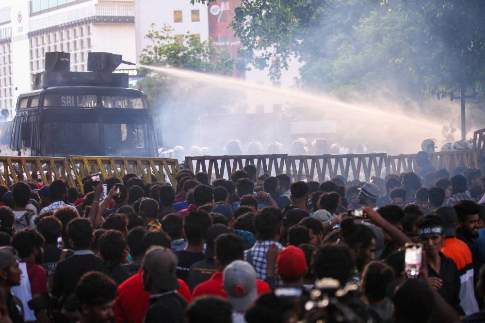 Police use a water canon to disperse demonstrators taking part in an anti-government protest demanding the resignation of Sri Lanka’s President Gotabaya Rajapaksa over the country’s crippling economic crisis, in Colombo on July 9, 2022. ― AFP pic