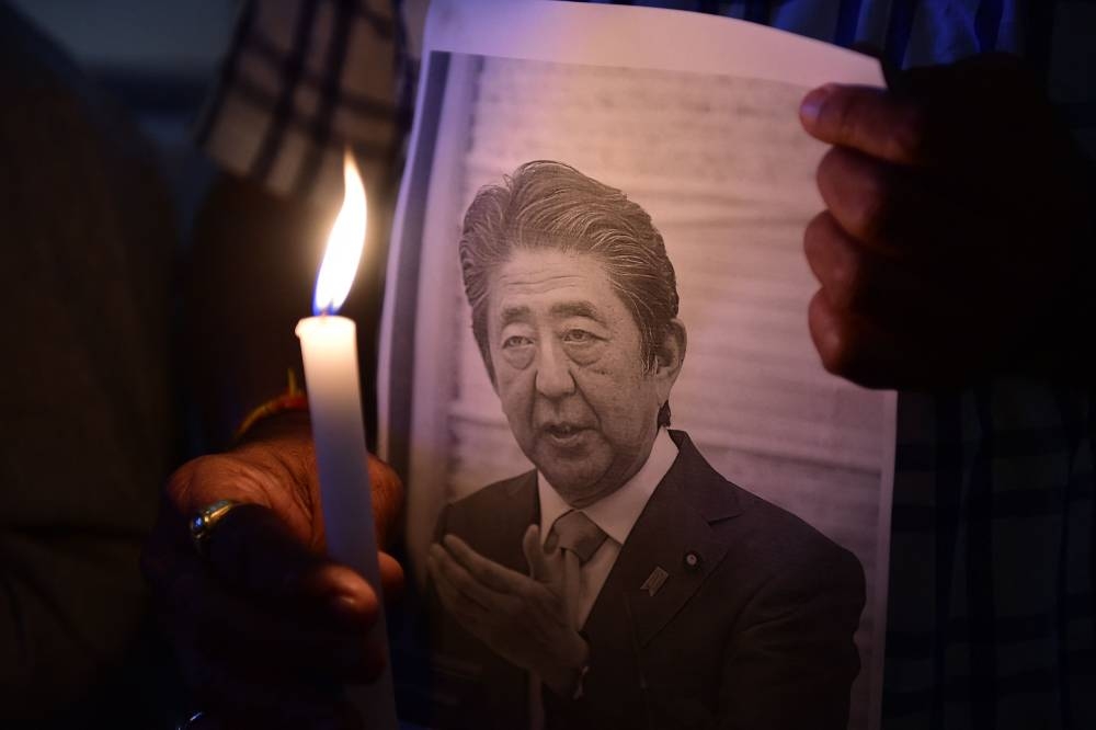 Members of the Japan information and study centre hold a candlelight vigil to pay tribute to the late former prime minister of Japan Shinzo Abe, at Ahmedabad Management Association in Ahmedabad on July 9, 2022, after Abe was shot dead during a campaign speech on July 8 in Nara. ― AFP pic