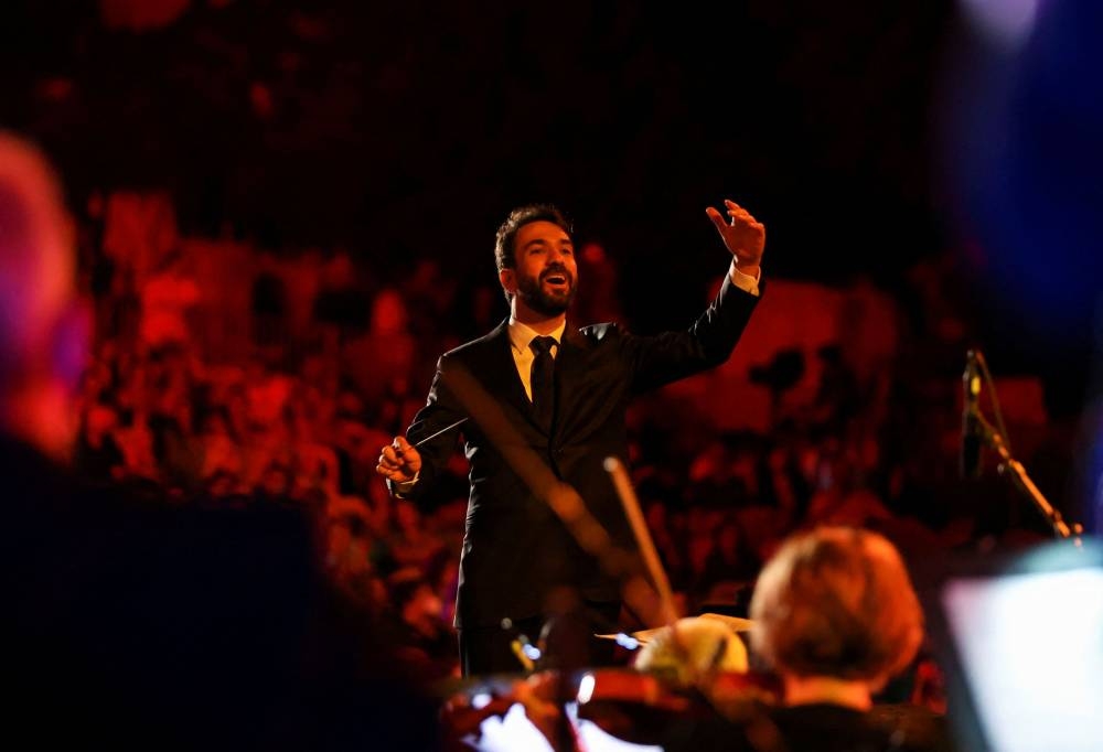 Lebanese conductor Lubnan Baalbaki performs during the opening of Baalbeck International Festival, in Baalbeck, Lebanon July 8, 2022. — Reuters pic