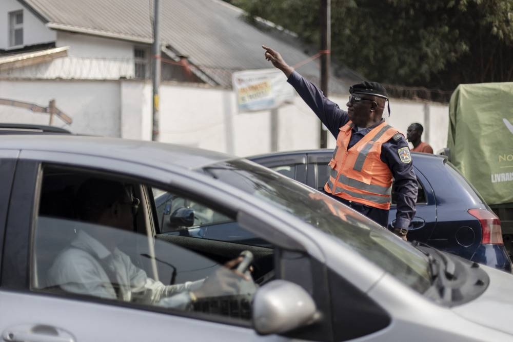 Jean-Pierre Beya, a traffic police officer, directs traffic on a street in Kinshasa, Democratic Republic of Congo, on July 5, 2022. — AFP pic