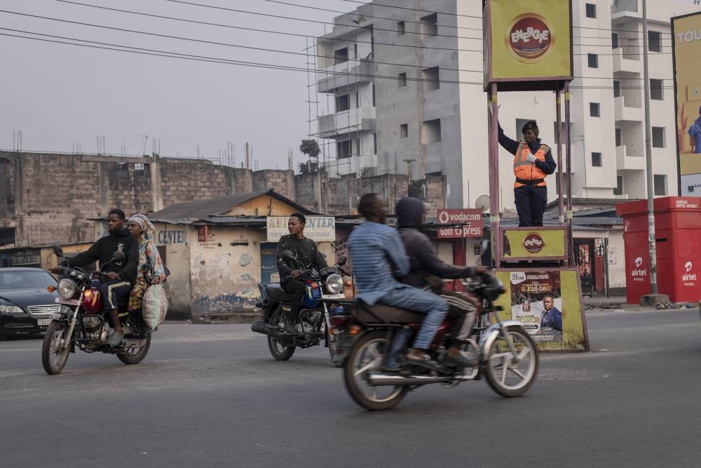 Cecile Bakindo, a traffic police officer, directs traffic on a street in Kinshasa, Democratic Republic of Congo, on July 6, 2022. — AFP pic