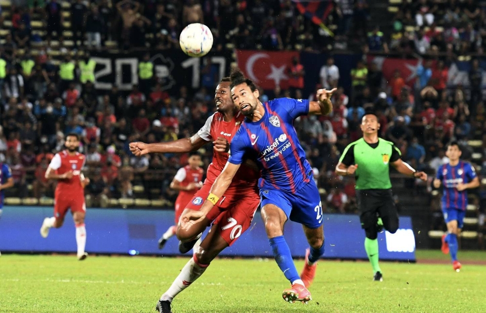 Sabah FC’s Jose Embalo in action against Johor Darul Ta’zim’s La’Vere Corbin-Ong at Stadium Likas, Kota Kinabalu, July 15, 2022. — Bernama pic 