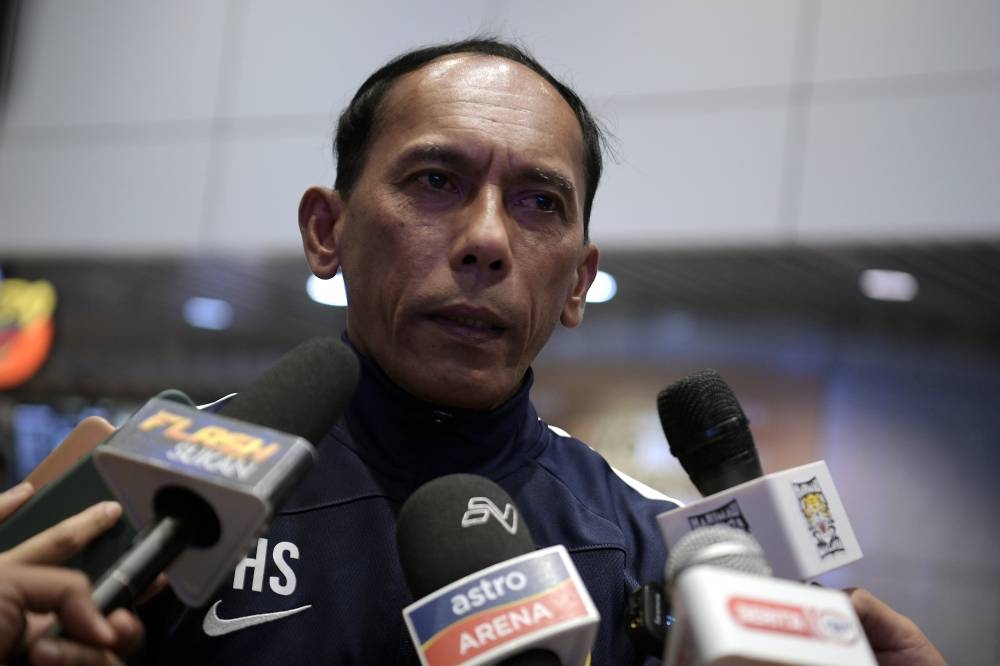 Under-19 head coach Hassan Sazali Waras speaks to the media at the Kuala Lumpur International Airport (KLIA) in Sepang July 16, 2022. — Bernama pic