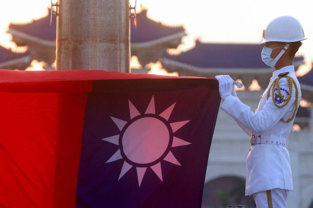 Honour guards lower the Taiwan flag during sunset hours at Liberty Square in Taipei, Taiwan, July 28, 2022. — Reuters pic