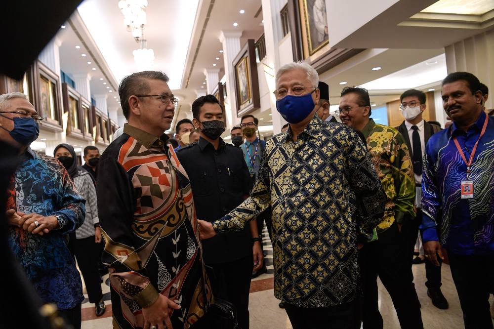 Prime Minister Datuk Seri Ismail Sabri Yaakob speaks to Pulai MP Datuk Salahuddin Ayub at Parliament, Kuala Lumpur July 28, 2022. — Bernama pic