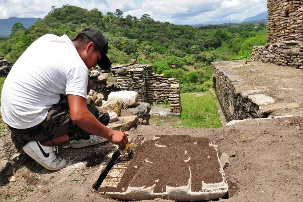 An archaeologist of the National Institute of Anthropology and History (INAH) works in the area where remains were found that reveal cremation rites for Mayan rulers at Tonina pyramid, in Ocosingo, Chiapas state, Mexico. — Handout by INAH via Reuters