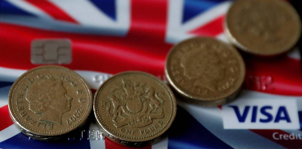 British pound coins are seen on top of a Union Jack themed Visa credit card in this photo illustration taken in Manchester March 13, 2017. — Reuters pic