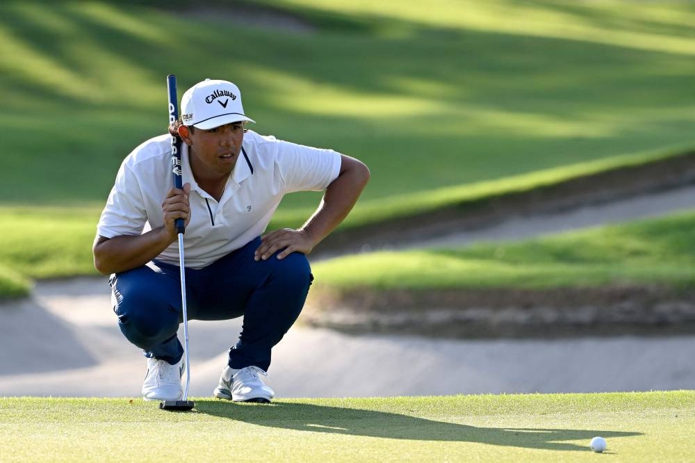 Gavin Green of Malaysia watches the ball as he plays a shot during the International Series Singapore golf tournament at Tanah Merah Country Club in Singapore, August 11, 2022. — Paul Lakatos/Asian Tour handout pic via AFP