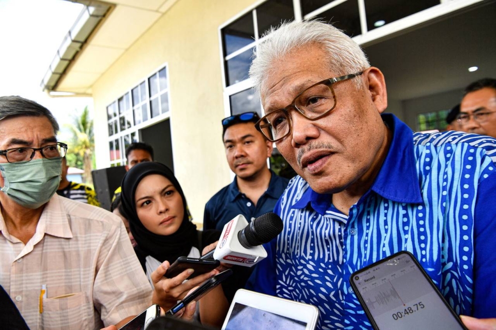 Minister of Home Affairs who is also Member of Parliament for Larut, Datuk Seri Hamzah Zainudin (right) is met by members of the media in Batu Kurau, June 25, 2022. — Bernama pic