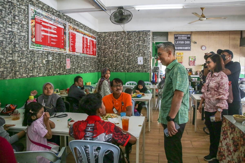 Finance Minister Datuk Seri Tengku Zafrul Abdul Aziz talks to people during a walkabout along Jalan Raja Abdullah in Kuala Selangor August 14, 2022. — Picture by Yusof Mat Isa