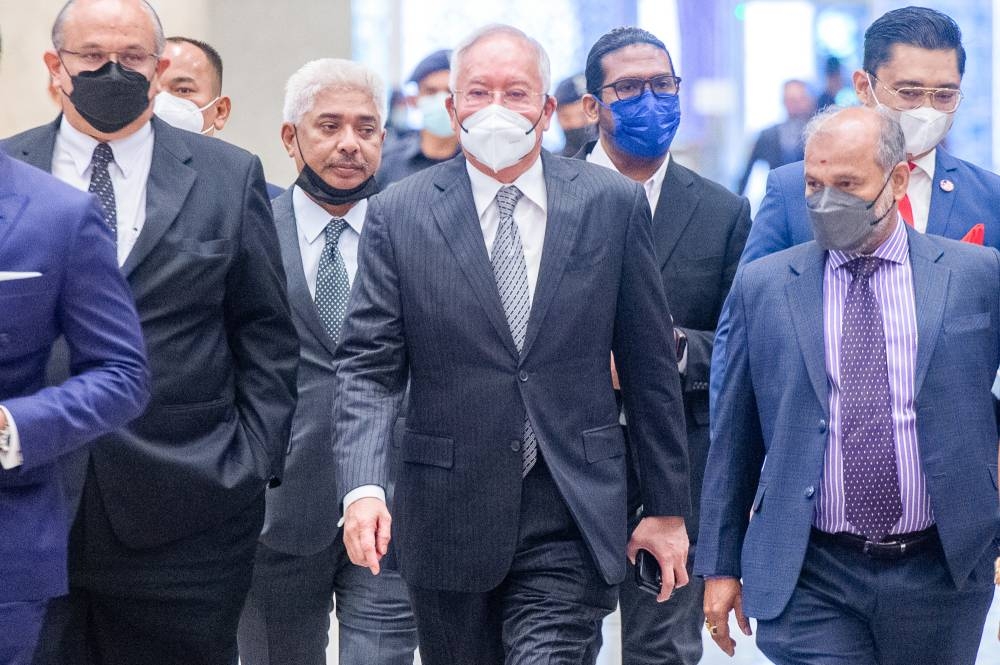 Datuk Seri Najib Razak (centre) arrives at the Palace of Justice in Putrajaya August 16, 2022. — Picture by Shafwan Zaidon