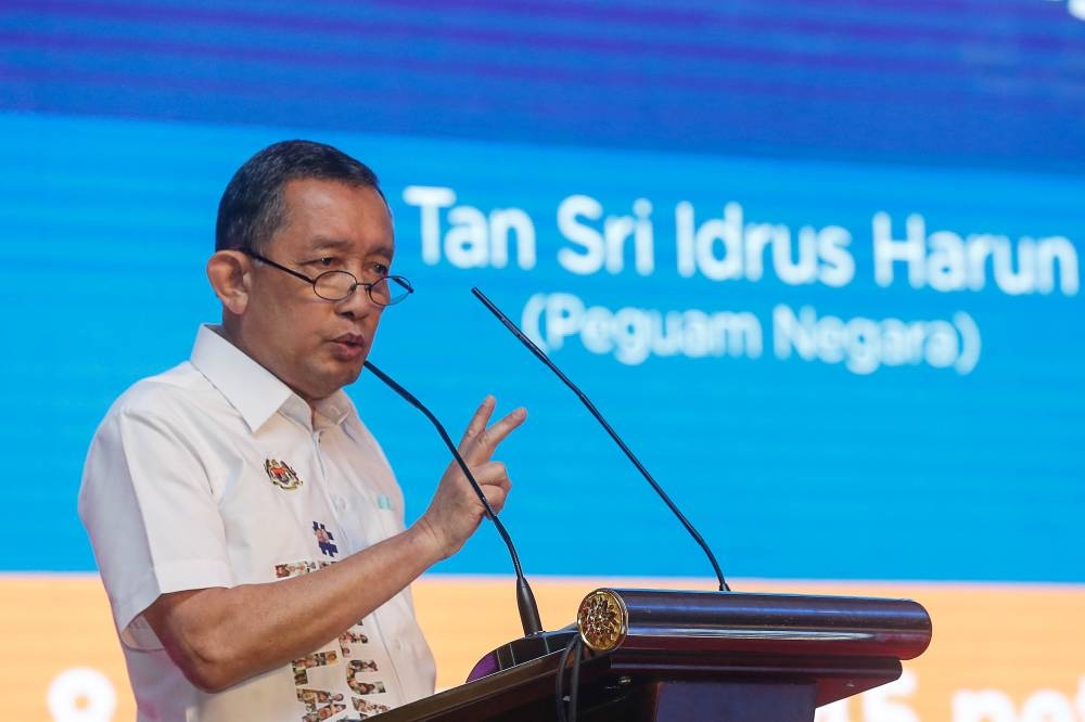 Attorney General Tan Sri Idrus Harun delivering his speech during the Keluarga Malaysia Symposium here at the Putrajaya International Convention Centre August 21, 2022. — Picture by Sayuti Zainudin