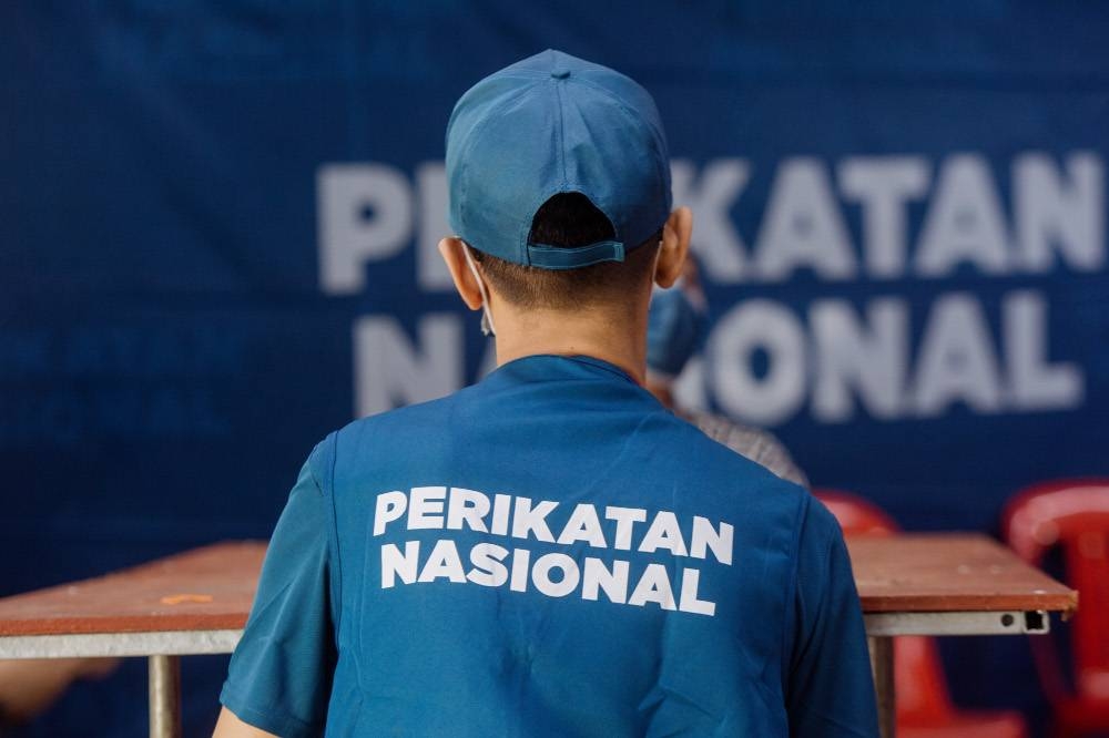 The Perikatan Nasional (PN) logo appears on a volunteer’s apparel at the PN command centre in Kota Laksamana, Melaka, November 10, 2021. — Picture by Shafwan Zaidon