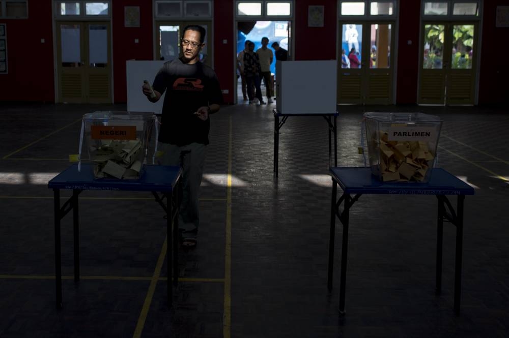 Registered voters cast their vote during polling day of Malaysia’s 14th general election at SMK Meru, Klang, May 9, 2018. Living standards often make the battleground that elections are won or lost on. As recent as the 2018 polls, living cost pressure blamed on the goods and services tax fuelled a voter backlash that ended six decades of Barisan Nasional rule. — Picture by Mukhriz Hazim