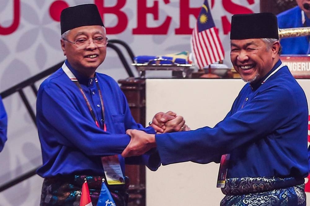 Umno vice president Datuk Seri Ismail Sabri Yaakob (left) after his speech together with party president Datuk Seri Ahmad Zahid Hamidi (right) at the 2021 Umno General Assembly at the Kuala Lumpur World Trade Centre March 19, 2022. ― Picture by Hari Anggara