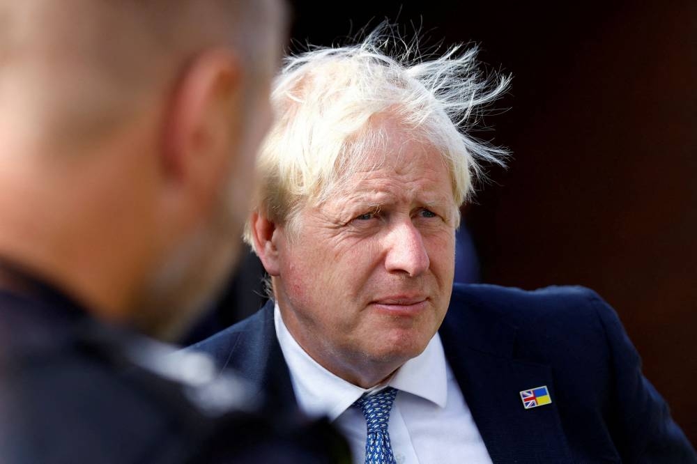 Boris Johnson, forced to announce his resignation in July after months of scandal drained away support for his administration, will hand over power on Tuesday. — Reuters pic