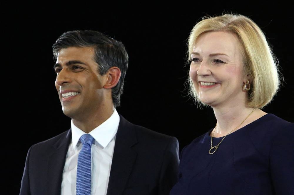 Rishi Sunak, Britain’s former Chancellor of the Exchequer (left) and Britain’s Foreign Secretary Liz Truss, the final two contenders to become the country's next Prime Minister and leader of the Conservative party, stand together on stage during the final Conservative Party Hustings event at Wembley Arena, in London August 31, 2022. — AFP pic