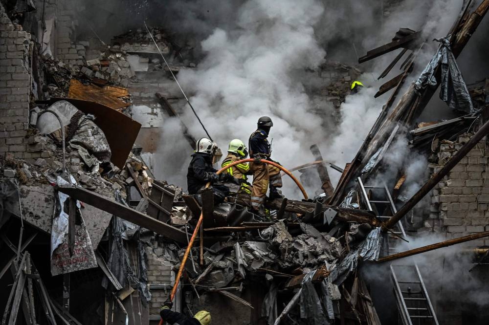 Firefighters extinguish a fire after an apartment was hit by a missile strike in Kharkiv, on September 6, 2022, amid the Russian invasion of Ukraine. — AFP pic