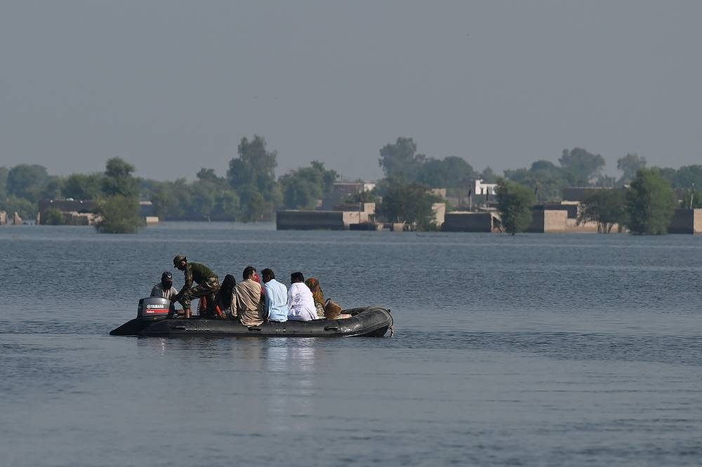 Members of Pakistan Navy personnel take part in a rescue operation in flooded Mehar city after heavy monsoon rains in Dadu district, Sindh province on September 9, 2022. — AFP pic