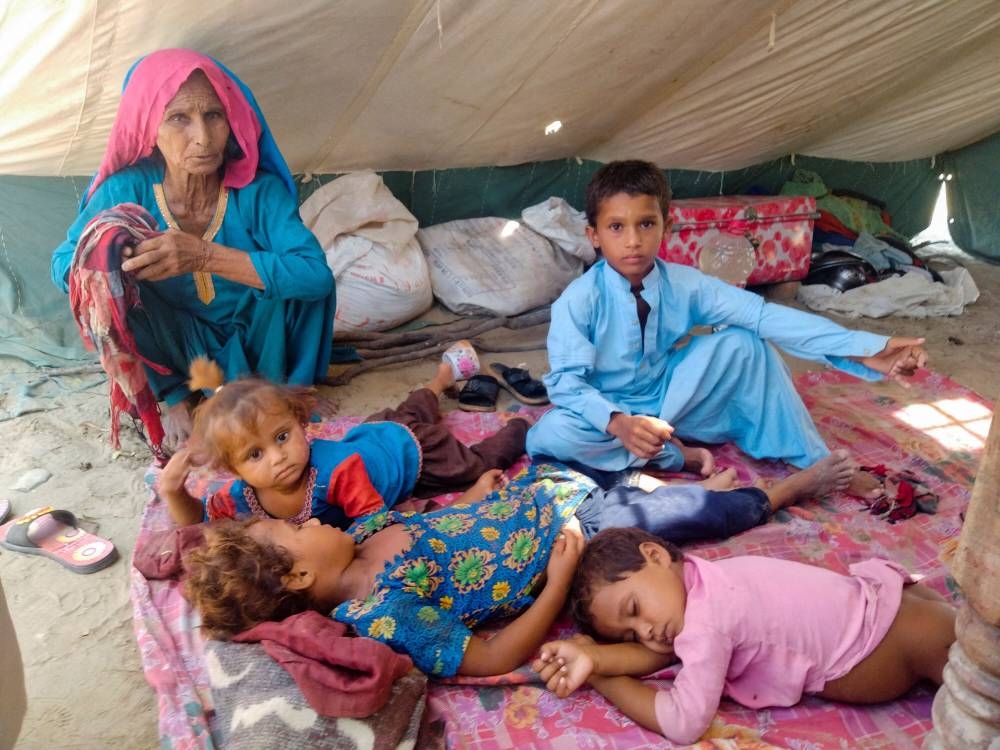 A woman, who is a flood victim, looks after children while taking refuge at a relief camp following rains and floods during the monsoon season, in Sehwan, Pakistan September 9, 2022. ― Reuters pic