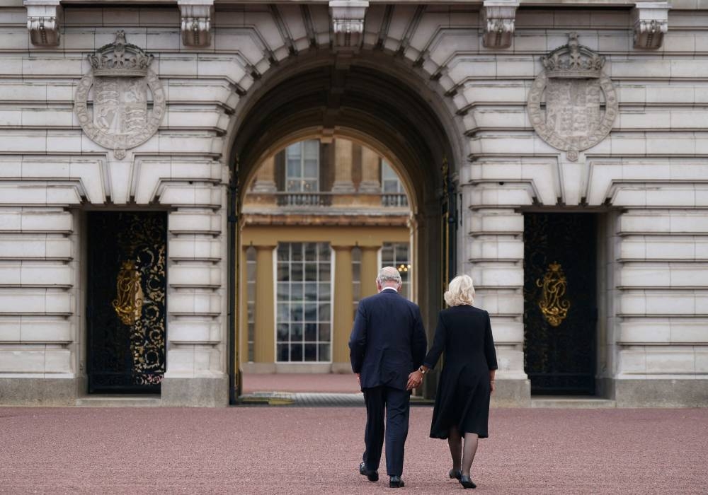 Britain’s King Charles III and Britain's Camilla, Queen Consort walk towards Buckingham Palace in London, on September 9, 2022, a day after Queen Elizabeth II died at the age of 96. ― AFP pic