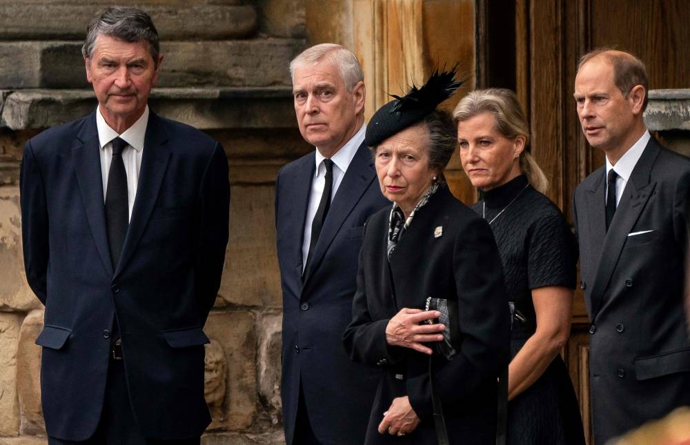 Vice Admiral Timothy Laurence, Britain's Prince Andrew, Duke of York, Britain's Princess Anne, Princess Royal, Britain's Sophie, Countess of Wessex and Britain's Prince Edward, Earl of Wessex await the arrival of the hearse carrying the coffin of the late Queen Elizabeth II, at the Palace of Holyroodhouse, in Edinburgh on September 11, 2022. — AFP pic