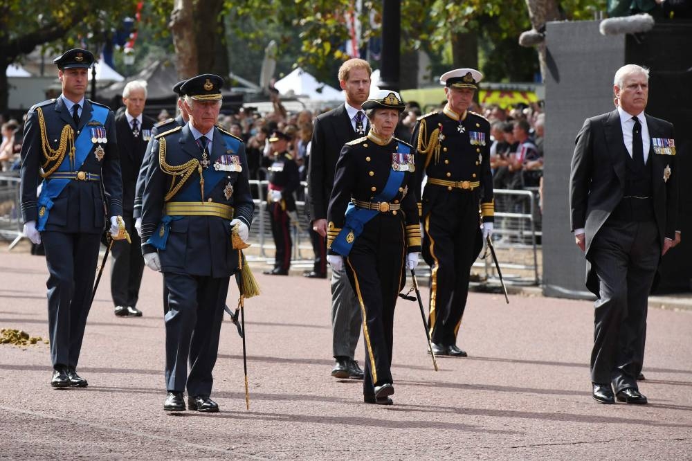 (Rear, from left): Prince William, Prince Harry, Vice Admiral Sir Timothy Lawrence (front, from left):) King Charles III, Princess Anne and Prince Andrew, walk the coffin of Queen Elizabeth II, adorned with a Royal Standard and the Imperial State Crown and pulled by a Gun Carriage of The King’s Troop Royal Horse Artillery, during a procession from Buckingham Palace to the Palace of Westminster, in London September 14, 2022. — Chris J Ratcliffe/Pool/AFP pic