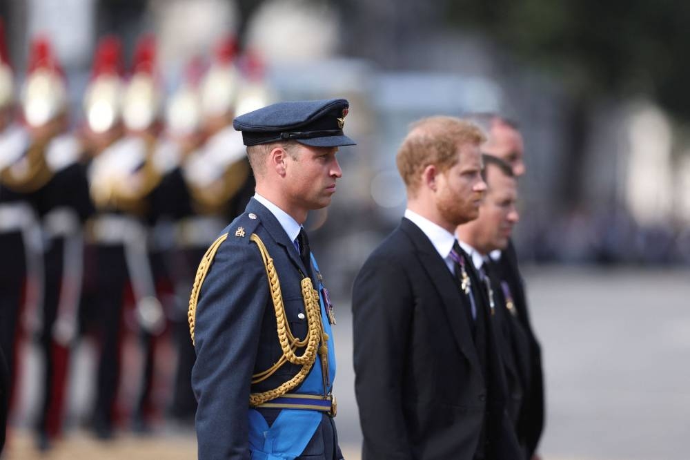 Prince William, Prince of Wales and Prince Harry, Duke of Sussex walk behind the coffin during the procession for the Lying-in State of Queen Elizabeth II on September 14, 2022 in London. — Richard Heathcote/Pool/Reuters pic