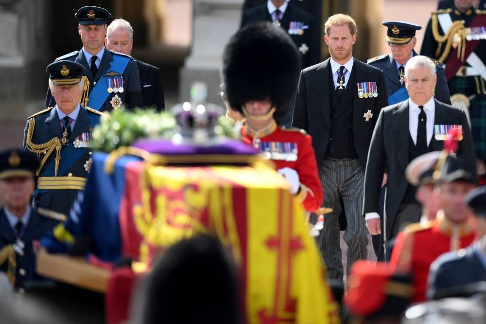 Britain’s King Charles III, Prince William, Prince of Wales, Earl of Snowdon, Prince Harry, Duke of Sussex and Prince Andrew, Duke of York walk behind the coffin of Queen Elizabeth II, adorned with a Royal Standard and the Imperial State Crown and pulled by a Gun Carriage of The King’s Troop Royal Horse Artillery, during a procession from Buckingham Palace to the Palace of Westminster, in London September 14, 2022. — Daniel Leal/Pool/Reuters pic 