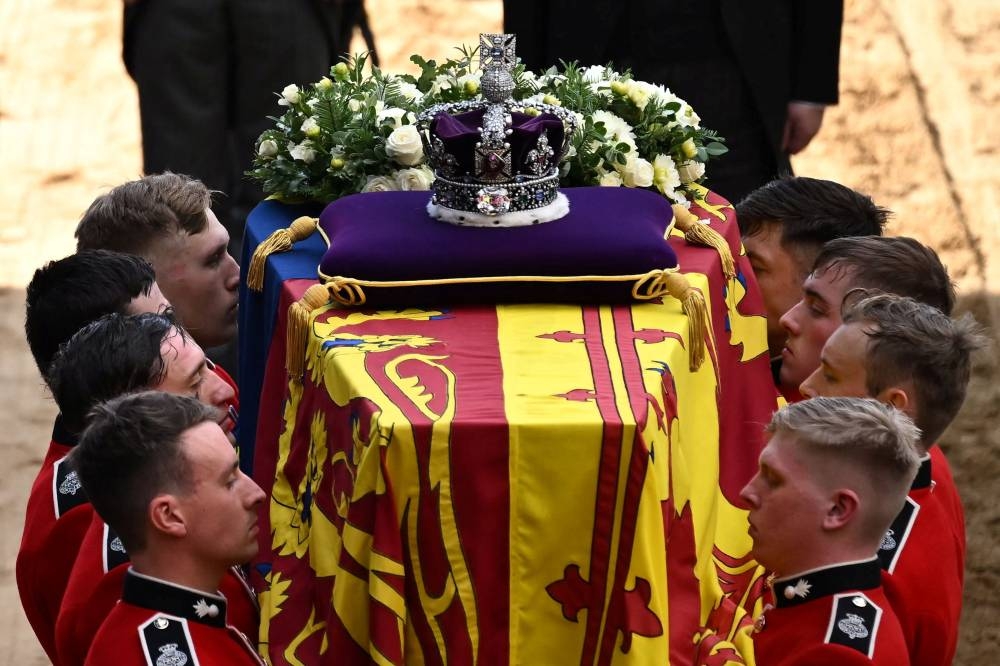 Pallbearers from The Queen's Company, 1st Battalion Grenadier Guards prepare to carry the coffin of Queen Elizabeth II into Westminster Hall at the Palace of Westminster in London on September 14, 2022, to Lie in State following a procession from Buckingham Palace. — Ben Stansall/Pool/Reuters pic