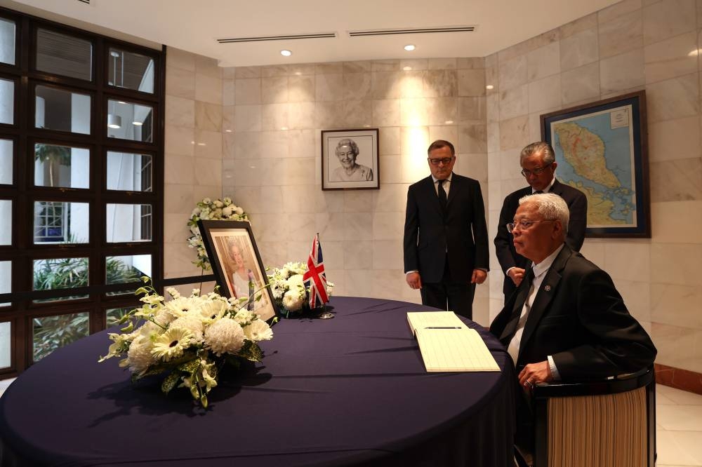 Prime Minister Datuk Seri Ismail Sabri Yaakob signs the condolence book for Her Majesty Queen Elizabeth II at the British High Commissioner’s Residence in Jalan Ampang, September 15, 2022. — Bernama pic 