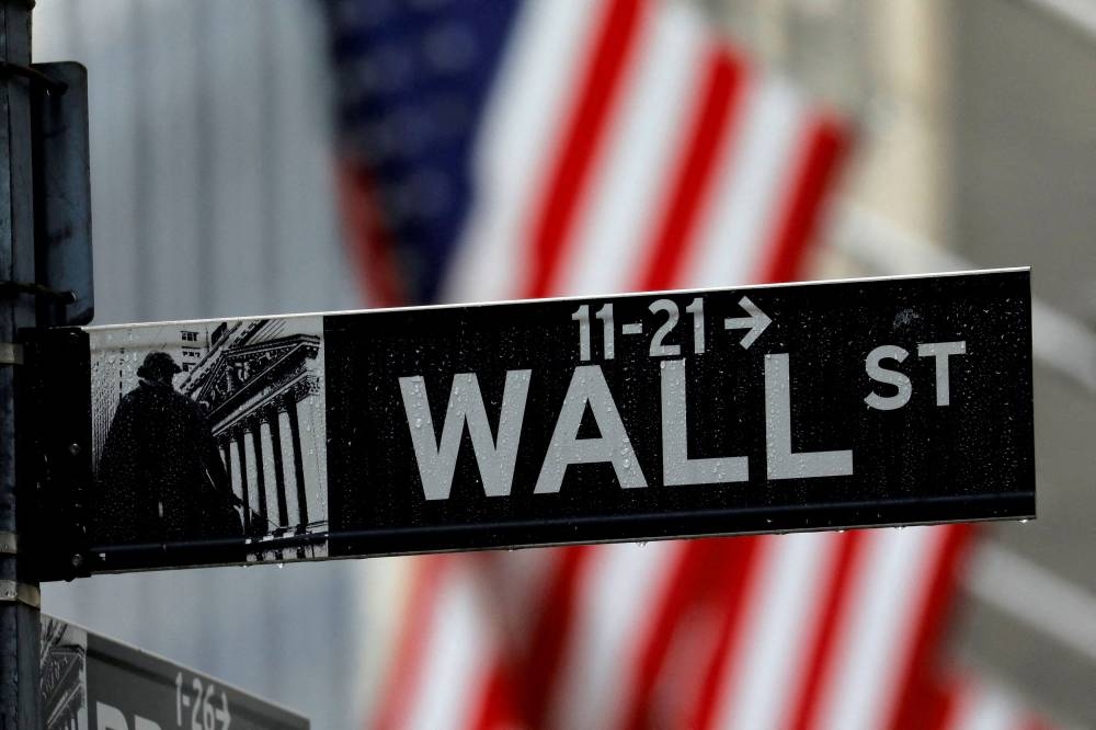 Raindrops hang on a sign for Wall Street outside the New York Stock Exchange in Manhattan in New York City, New York, US, October 26, 2020. — Reuters pic