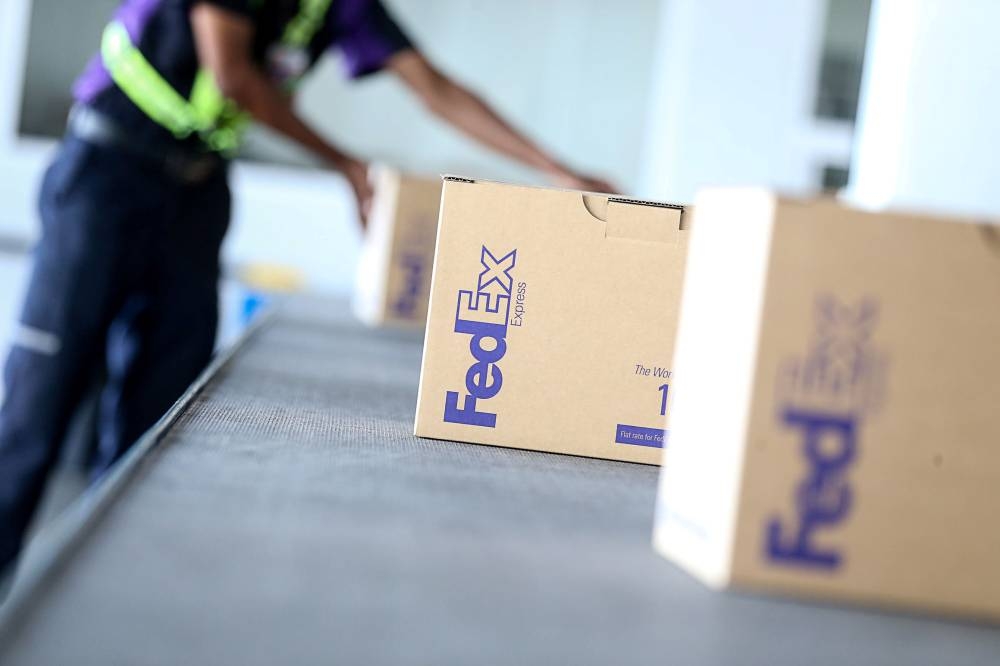 Shares of FedEx plunged more than 20 per cent after the company said it is closing stores, freezing hiring and parking aircraft. — PICTURE BY SAYUTI ZAINUDIN