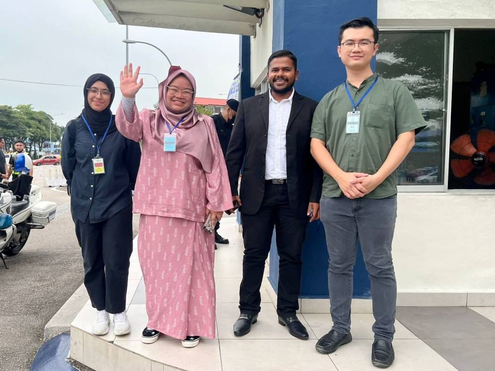 Malaysian United Democratic Alliance (Muda) deputy president Amira Aisya Abd Aziz (2nd left) at the Johor Baru South district police headquarters in Larkin, September 20, 2022. — Picture courtesy of Johor Perikatan Nasional (PN)