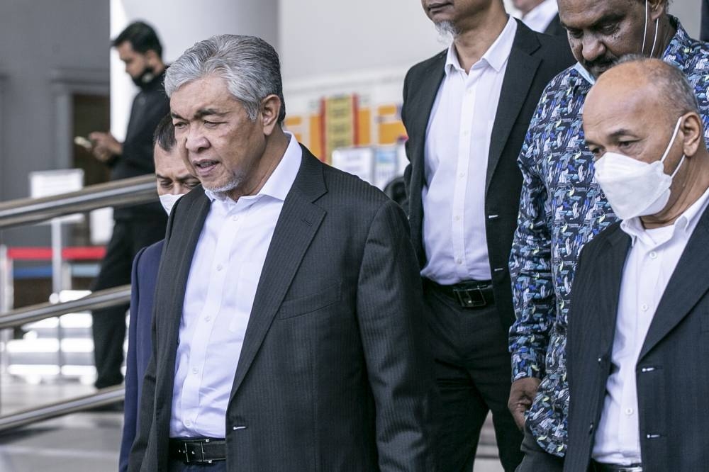 Former Deputy Prime Minister Datuk Seri Ahmad Zahid Hamidi (centre) leaving after his court case at Kuala Lumpur High Court, Sept 22, 2022. — Picture by Hari Anggara