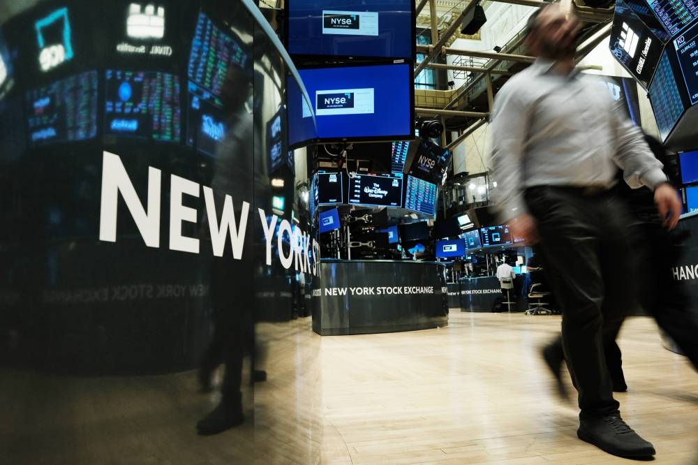 Traders work on the floor of the New York Stock Exchange on September 16, 2022 in New York City. — AFP pic