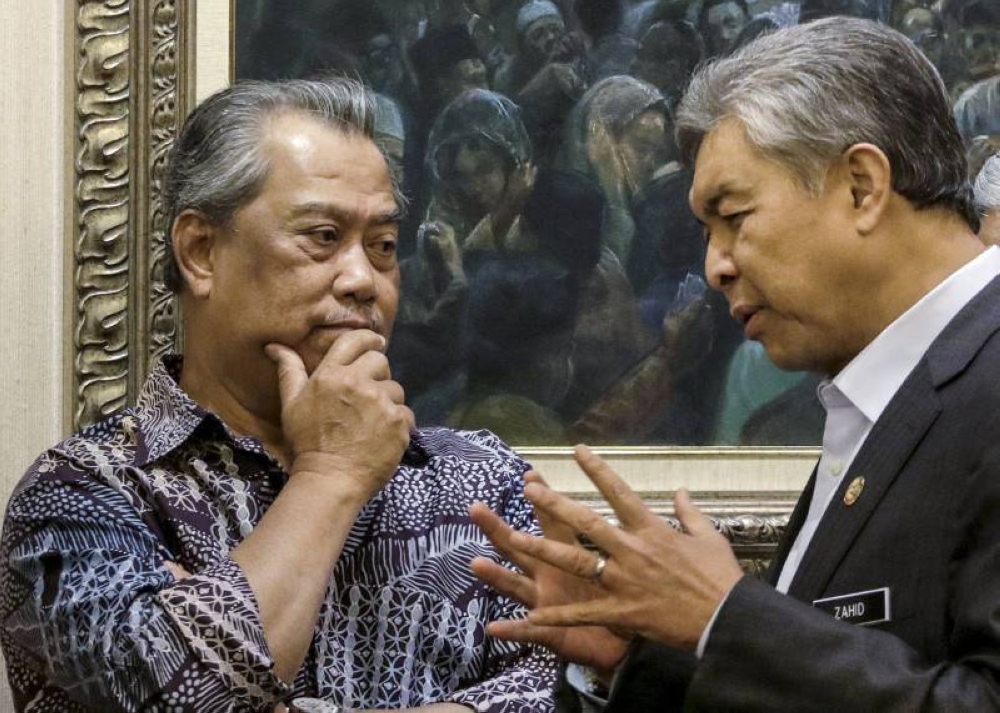 Tan Sri Muhyiddin Yassin (left) talks with Datuk Seri Ahmad Zahid Hamidi (right) before the Umno Supreme Council meeting in Kuala Lumpur in this file picture taken on September 9, 2015. — Reuters pic