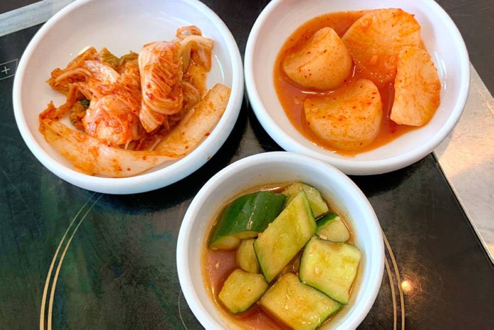 'Banchan' here includes red kimchi, spicy cucumber salad and cubed radish kimchi.