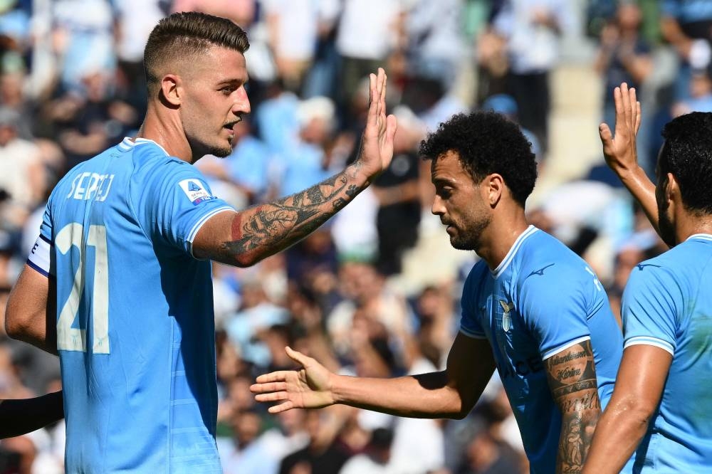 Lazio's Serbian midfielder Sergej Milinkovic-Savic (L) celebrates after scoring his side's 4th goal during the Italian Serie A football match between Lazio and Spezia on October 2, 2022 at the Olympic stadium in Rome. — AFP pic