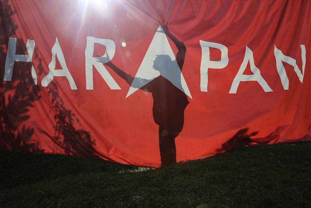 The shadow of a campaign worker is seen against a Pakatan Harapan flag at Pasir Panjang in Port Dickson October 11, 2018. Pakatan Harapan released its shadow Budget for 2023 today. — Picture by Yusof Mat Isa