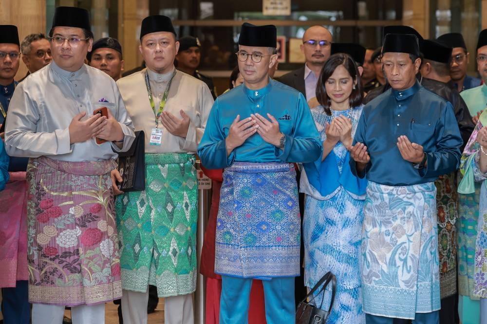 Finance Minister Datuk Seri Tengku Zafrul Abdul Aziz (centre) recites a prayer before departing for Parliament to table Budget 2023, outside the Finance Ministry in Putrajaya, October 7, 2022. — Picture by Shafwan Zaidon