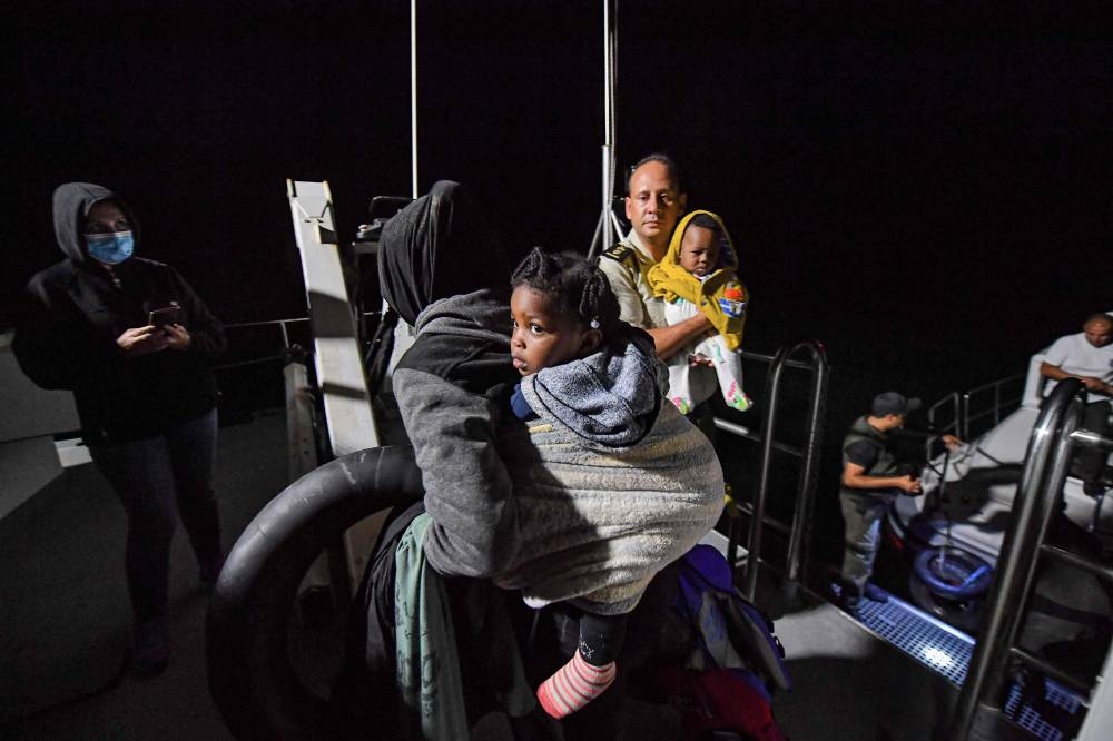 Migrants from sub-Saharan Africa are rescued off their boat late at night by the Tunisian National Guard at sea about 50 nautical miles in the Mediterranean sea off the coast of Tunisia's central city of Sfax on October 4, 2022. — AFP pic