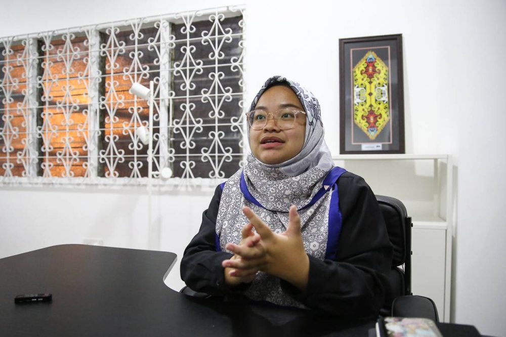 Muda deputy president Amira Aisya Abdul Aziz speaks to Malay Mail during an interview at her office in Petaling Jaya August 18, 2022. — Picture by Yusof Mat Isa