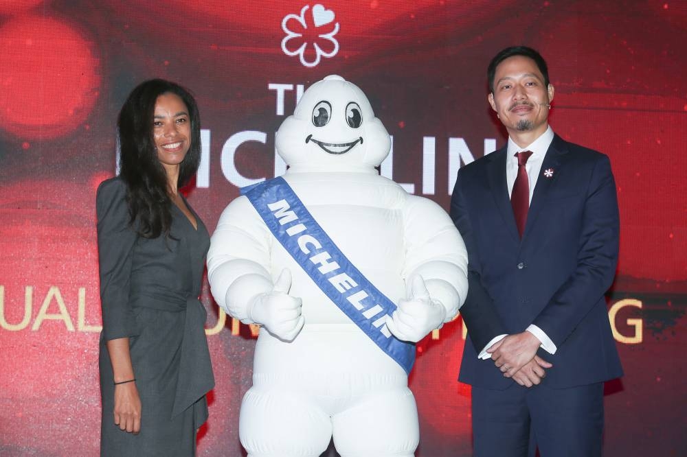 Michelin Experiences director of communications Elisabeth Boucher-Anselin and managing director of Michelin Malaysia, Singapore, and Brunei Prichapakorn Dangrojana with the Michelin Man at the Michelin Guide for KL and Penang launch at Mitec, October 20, 2022. — Picture by Choo Choy May